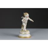 A Meissen porcelain standing figure of ‘Cupid Blindfolded’, on round simulated marble socle with