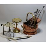 A 19th century copper & brass helmet-shaped coal scuttle; three various fire implements; two