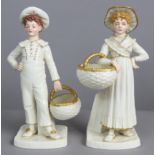 A pair of Royal Worcester porcelain ivory & gilt standing boy & girl figures, the faces &hands