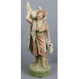 A Royal Dux porcelain standing figure of a male water-carrier, in eastern style dress, 19½” high,