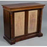 A regency rosewood chiffonier with rectangular overhang top above a pair of velvet-lined glazed