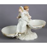 A Royal Worcester porcelain ivory & gilt “Kate Greenaway” group of boy & girl figures, the faces &