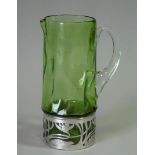 An early 20th century sea-green glass & pewter-mounted jug of textured cylindrical form with applied