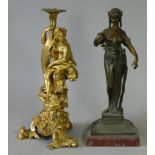 A 19th century French ormolu figural candlestick with a classical figure seated on the dolphin
