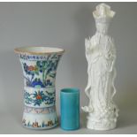A 20th century white-glazed figure of Guanyin, 15” high; a ditto woucai-decorated vase, 9½”