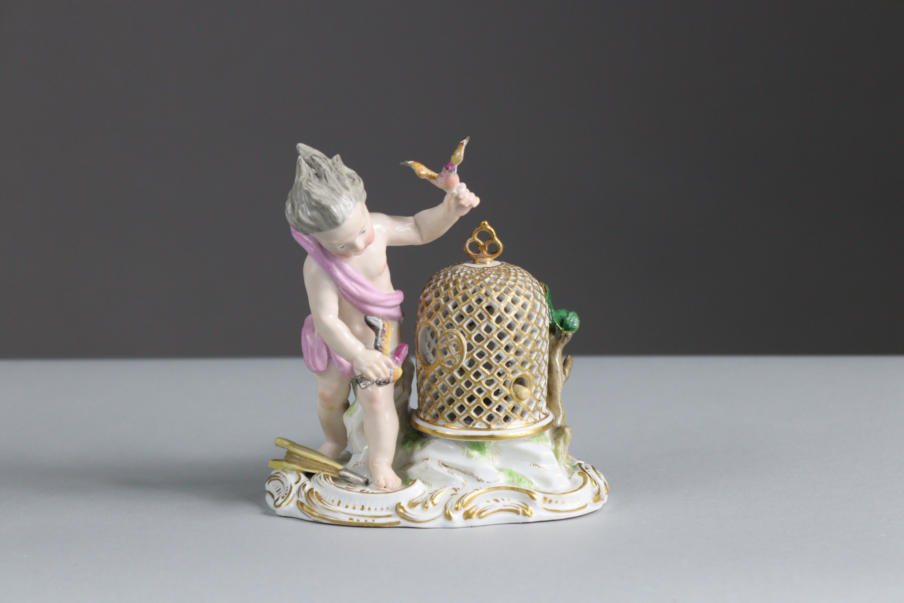 A Meissen porcelain figure of a putto with birdcage & birds, representing the element of Air, on - Bild 2 aus 3