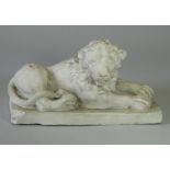 An early-mid 20th century plaster model of a recumbent lion, on rectangular plinth base; 10½” x 5” x