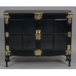 A late 19th century Aesthetic movement ebonised cabinet in the oriental style, with engraved brass