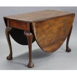 A 19th century mahogany oval drop-leaf dining table in the mid-18th century style with carved