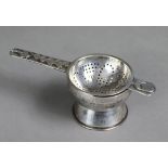 A Gwendoline Whicker of Falmouth Arts & Crafts silver tea strainer with acorn & oak leaf decoration,