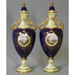 A pair of Coalport porcelain two-handled vases & covers, each with gilt-decorated & blue ground