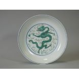 A Chinese porcelain shallow dish, with painted dragon decoration in famille verte enamels,