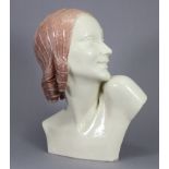 An Art Deco ceramic bust of a young woman, her head in profile turned to the left, signed “GUERO” to