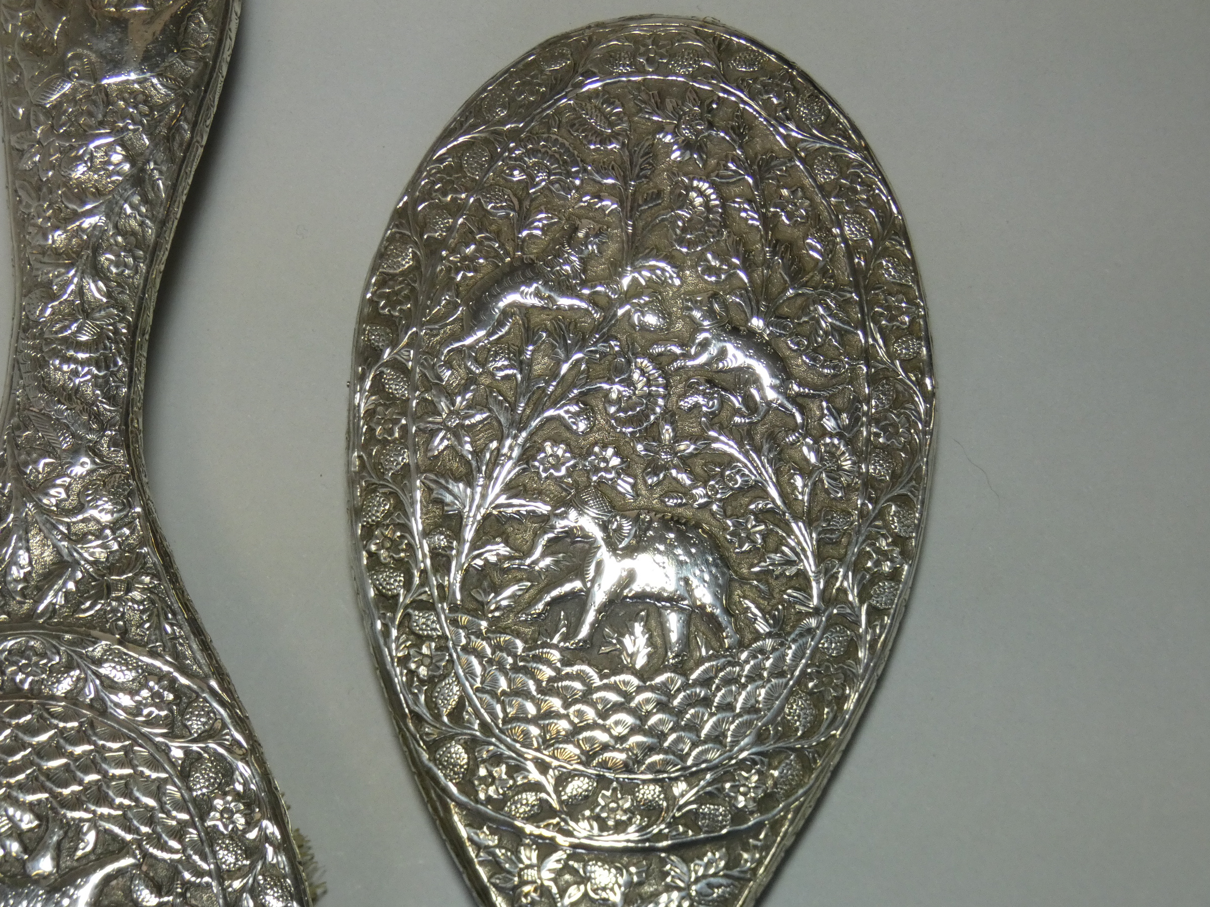 A late 19th/early 20th century Indian silver-backed hand mirror & matching hairbrush, with all- - Image 2 of 4