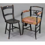 An early 20th century ebonised wooden elbow chair with brass roundel to back, padded seat, & on turn