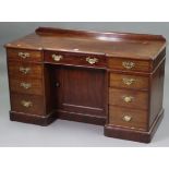 A late 19th/early 20th century MAHOGANY INVERTED BREAK-FRONT KNEE-HOLE DESK STAMPED “HEAL & SON