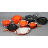 Six various Cousances (French) orange enamelled cooking pots & dishes; two Le Creuset cooking