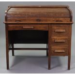 An early/mid 20th century Cookes of Finsbury Ltd. oak kneehole office desk, the top enclosed by a