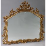 A reproduction gilt frame overmantel mirror with rounded top & with pierced foliate border, 47½”