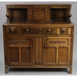 A reproduction oak court cupboard, the upper part enclosed by a linen-fold panel door to centre