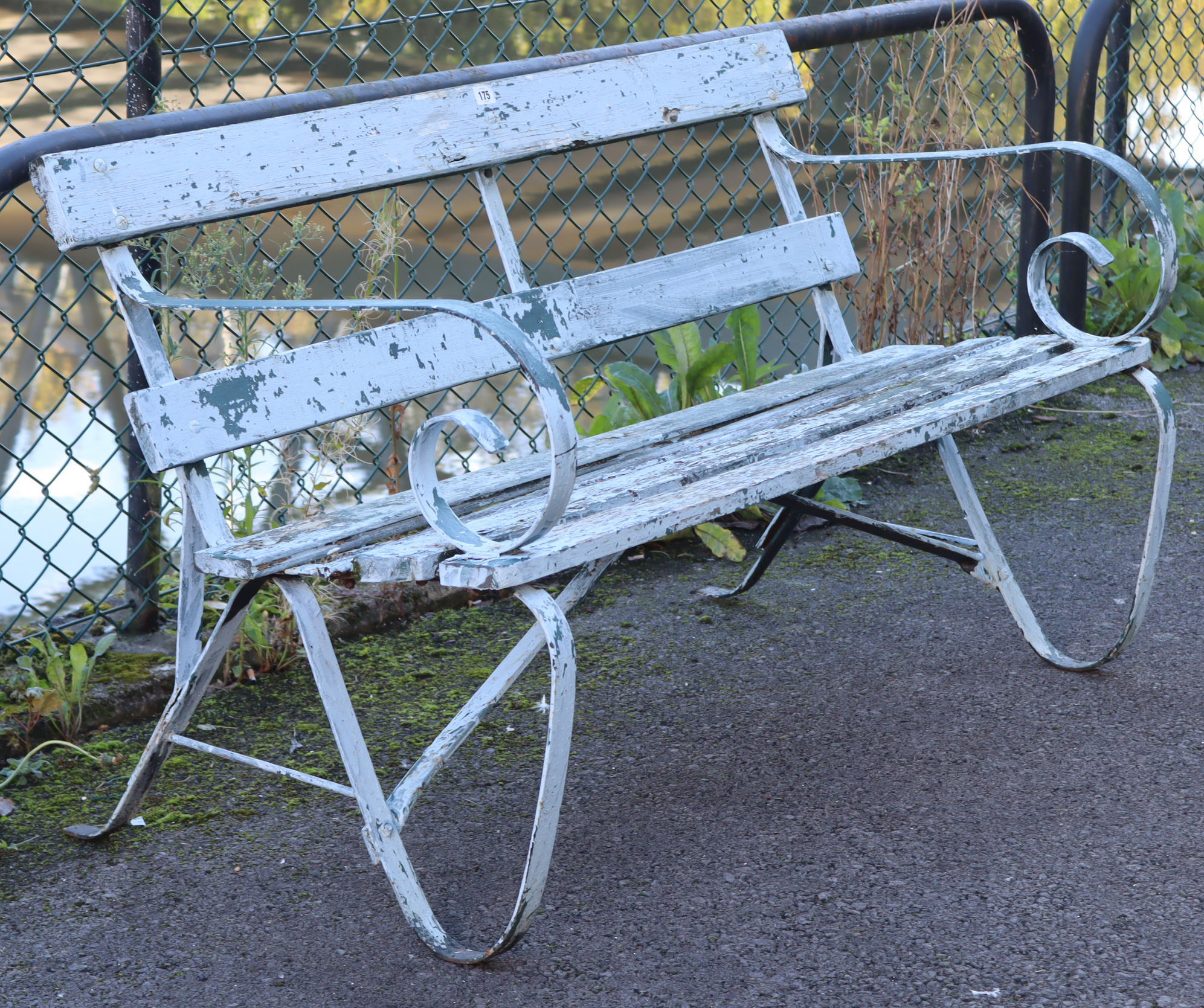 A pale grey painted wooden & wrought-iron garden bench, 48” long (w.a.f.).