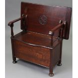 A small oak monk’s bench with fold-over top, hinged box-seat, with panelled sides & on bun feet,