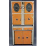 A mid-20th century white & orange painted wooden tall kitchen cabinet fitted with an arrangement
