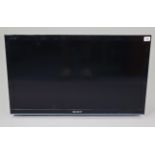 A Sony 31” LED wall-mounted television with remote control.