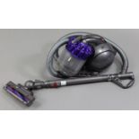 A Dyson cylinder vacuum cleaner.
