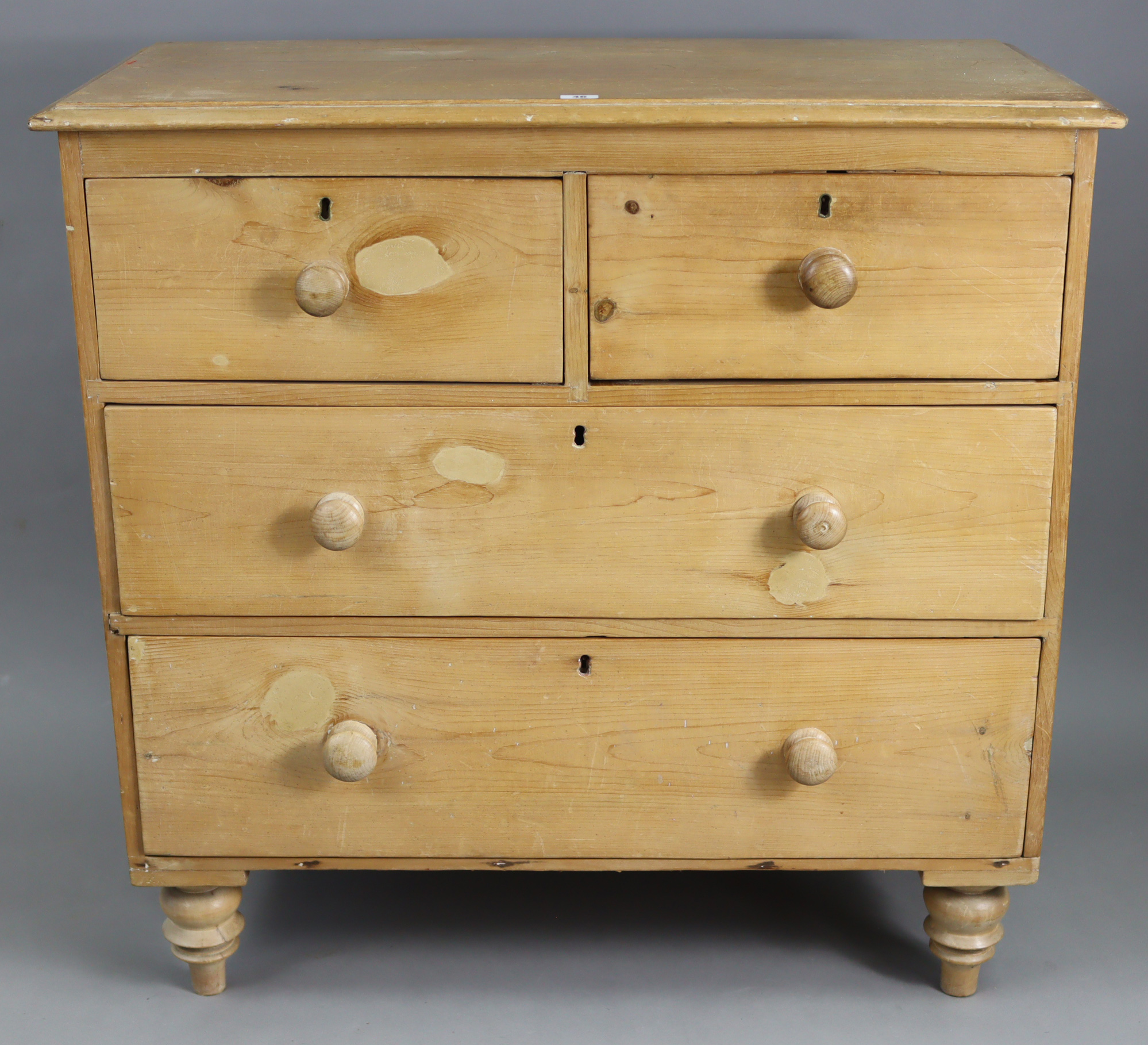 A pine small chest, fitted two short & two long graduated drawers with turned knob handles, & on