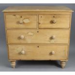 A pine small chest, fitted two short & two long graduated drawers with turned knob handles, & on