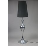 A chrome-plated standard lamp with ovoid-shaped centre column, & on round pedestal foot, with shade,