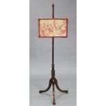 An early 19th century mahogany pole screen with turned column & three splay legs with a later