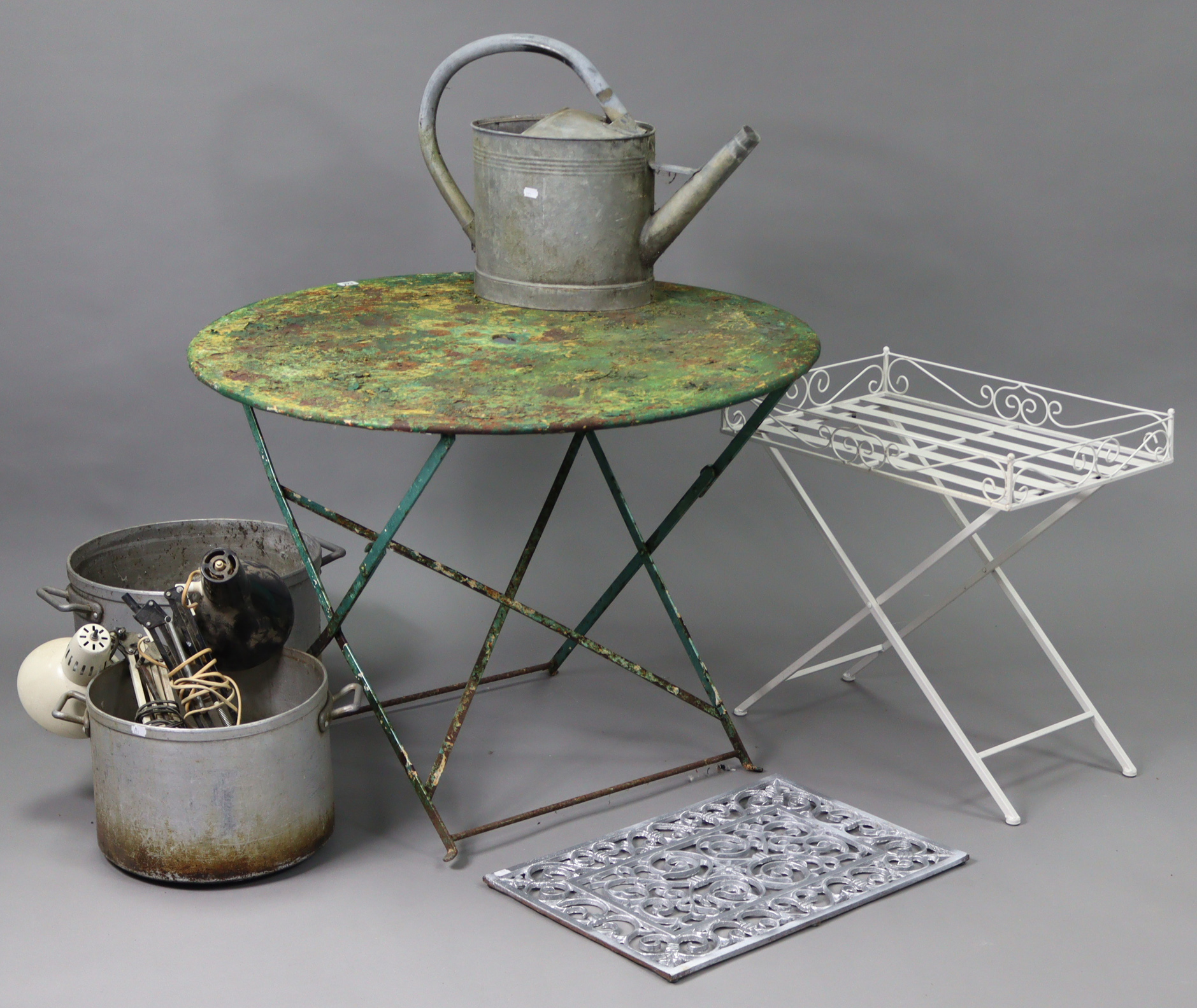 A green painted metal garden table with circular fold-away top, & on square legs, 37¾” diam. x