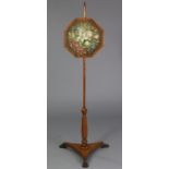 A William IV maple pole banner screen inset octagonal floral needlework panel, on turned centre