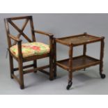 A carved oak rectangular two-tier tea trolley on square supports with castors, 26” wide x 26½” high;