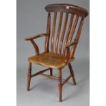 A lath-back elbow chair with hard seat, & on turned legs with spindle stretchers.