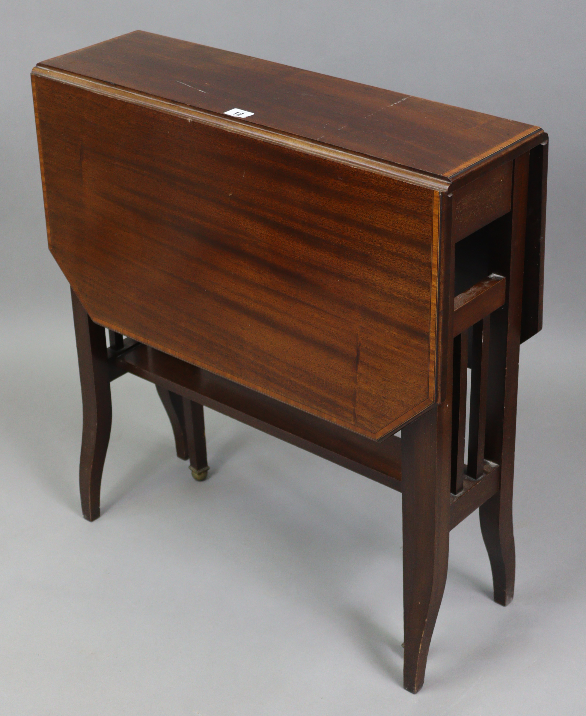 A late 19th/early 20th century inlaid-mahogany Sutherland table with canted corners to the