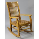 A hardwood rocking chair with hard seat, & on square supports with plain stretchers.