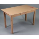 A pale brown painted wooden office table fitted centre frieze drawer, & on four square legs, 48”