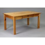 A pine kitchen table with rectangular top, fitted frieze drawer to one side, & on four square