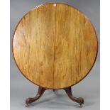 A 19th century mahogany dining table with circular tilt-top, & on a vase-turned centre column &