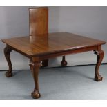 An early 20th century mahogany extending dining table with moulded edge & canted corners to the