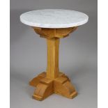 A light oak occasional table with square centre column & block feet, & with a white marble