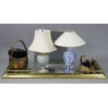 A brass fender, 62” long; two brass coal buckets; a spark guard; & two table lamps.