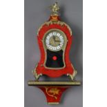 A reproduction bracket clock with black roman numerals to the brass & white enamel two-part