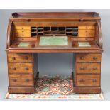 A Victorian mahogany large cylinder-front desk with moulded gallery to the top, above fully-fitted