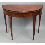 A Georgian inlaid-mahogany demi-lune tea table with fold-over top, & on four square tapered legs,