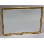 A large gilt-frame rectangular wall mirror with fluted border & inset bevelled plate, 26¼” x 37¾”.