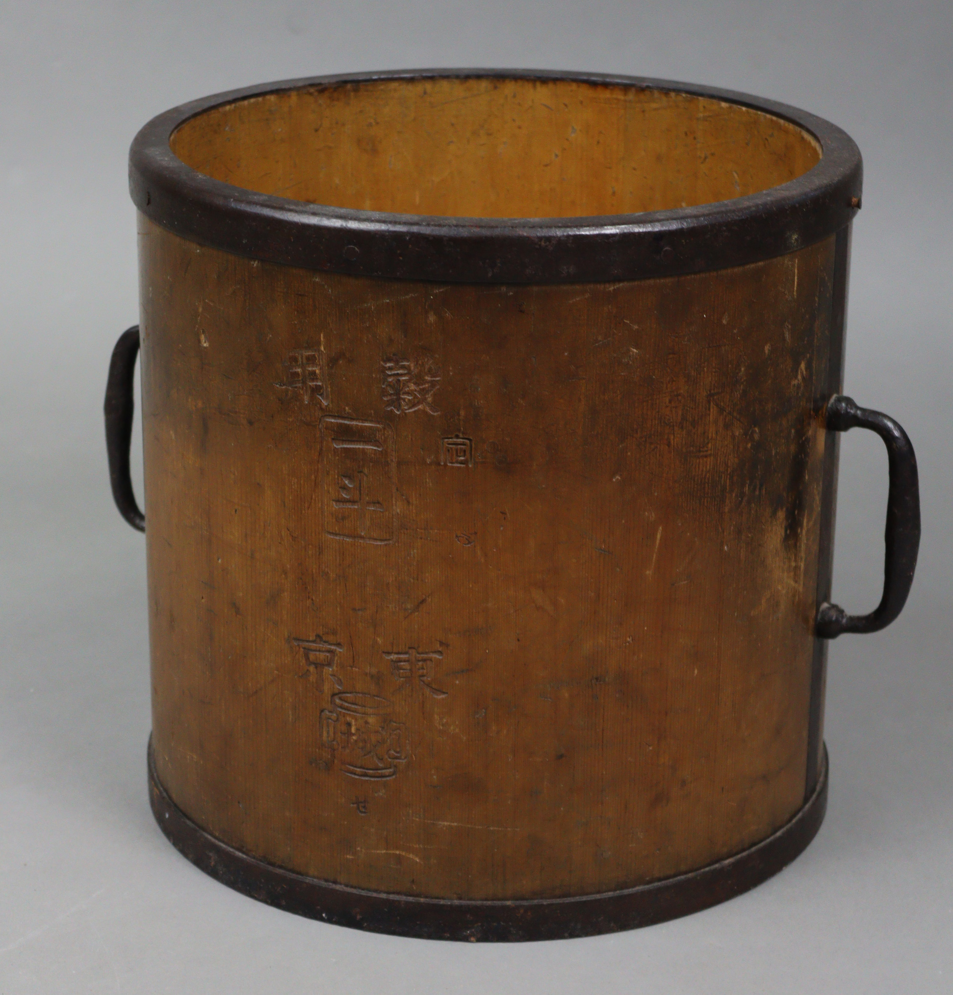 A Japanese hardwood cylindrical two-handled grain bucket with steel fittings, 12¼” diameter x 12¼”